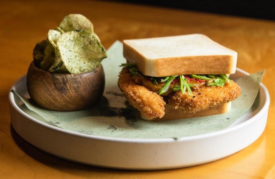 Fresh baked Kisser Japanese milk bread, fried chicken katsu, pickled ginger, cabbage, scallions, mayo, and Japanese curry with kabocha squash